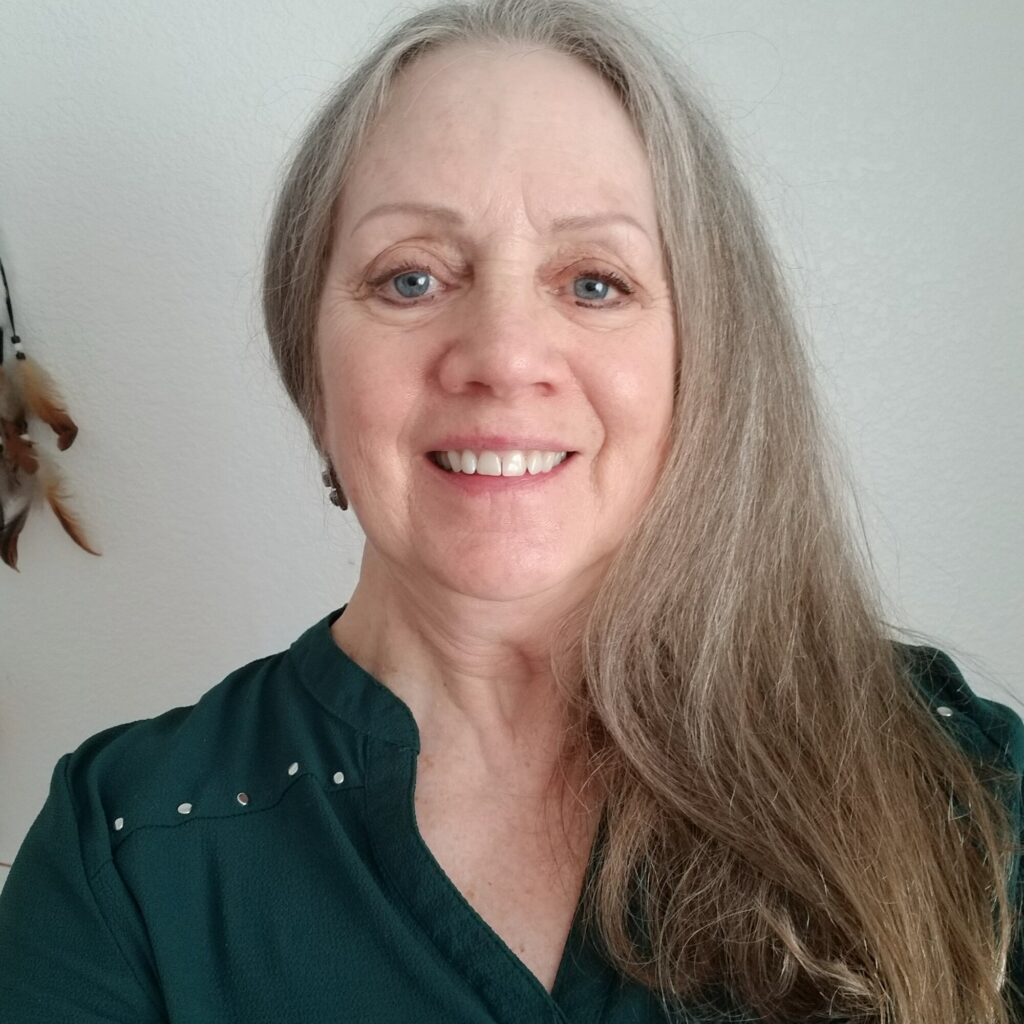 Kathi Cullen, smiling, in a green top